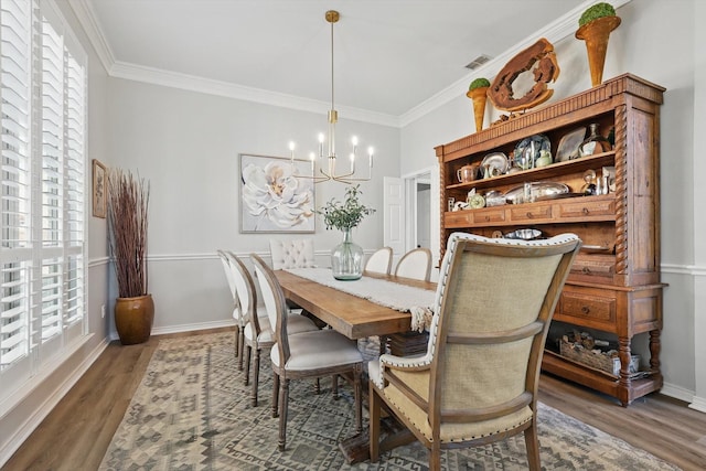 3921 Overlake Dr, Plano, TX 75023 - dining area featuring a chandelier, wood finished floors, ornamental molding, and baseboards