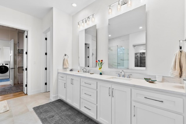 1206 Whisper Rock Dr, Rockwall, TX 75032 - full bathroom with washer / clothes dryer, a shower stall, double vanity, and recessed lighting