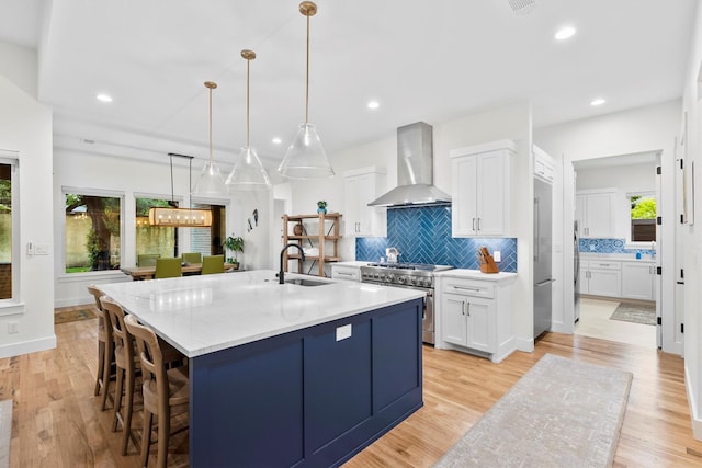 1206 Whisper Rock Dr, Rockwall, TX 75032 - kitchen featuring wall chimney exhaust hood, high quality appliances, a sink, plenty of natural light, and recessed lighting