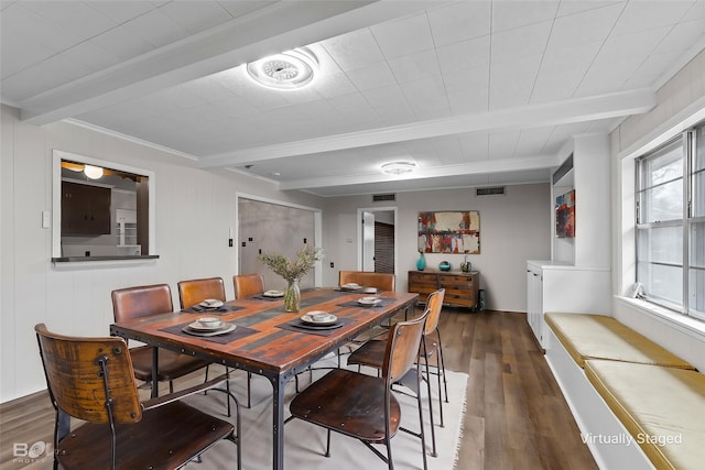 dining area featuring beam ceiling, wood finished floors, and ornamental molding