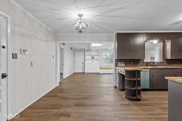 kitchen featuring crown molding, wood finished floors, a chandelier, open shelves, and wood counters