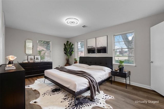 bedroom featuring wood finished floors and baseboards