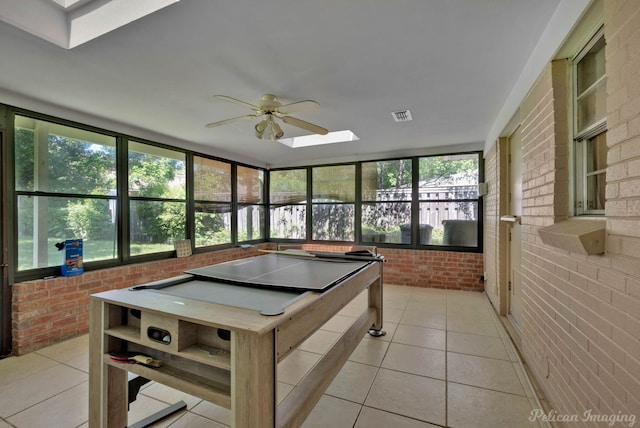 3315 Surrey Rd, Shreveport, LA 71105 - playroom with a skylight, brick wall, light tile patterned floors, and ceiling fan