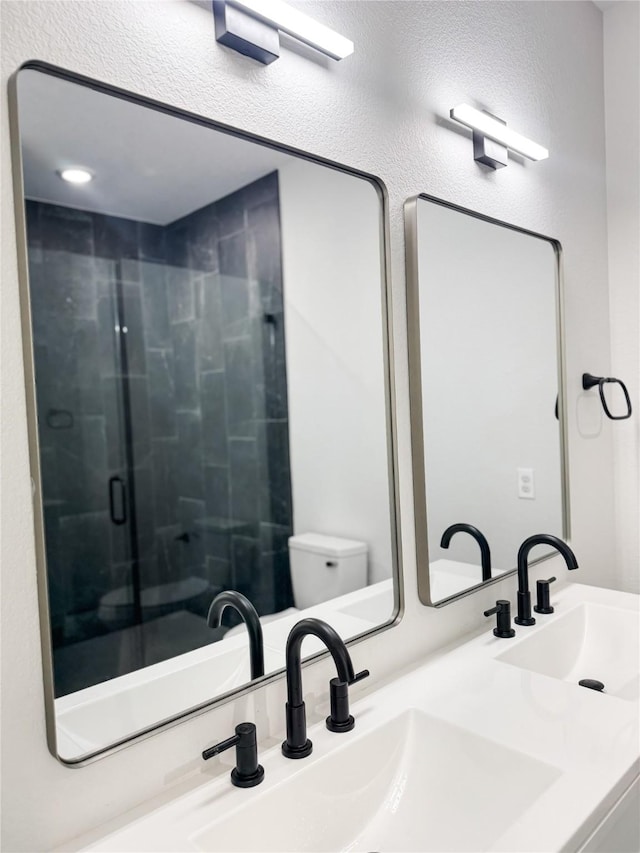 211 N 4th St, Grandview, TX 76050 - bathroom featuring a stall shower, toilet, and double vanity