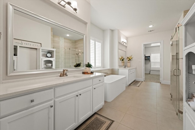 2101 Narrow Rd, Lucas, TX 75002 - bathroom featuring a shower stall, two vanities, tile patterned flooring, a bath, and recessed lighting