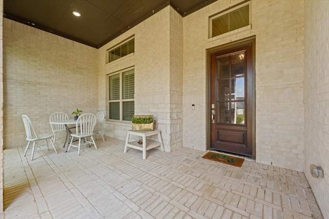 2101 Narrow Rd, Lucas, TX 75002 - doorway to property featuring outdoor dining area, covered porch, and brick siding