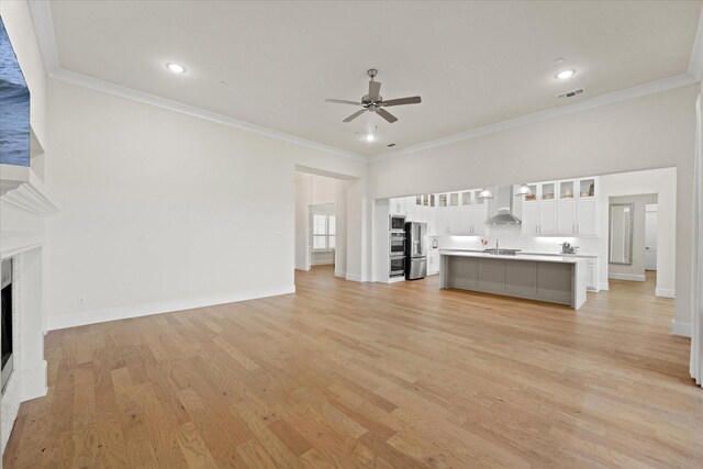 2101 Narrow Rd, Lucas, TX 75002 - unfurnished living room with a ceiling fan, a fireplace, light wood-style floors, crown molding, and baseboards