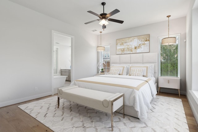 1609 Colonnade Ct, Mckinney, TX 75069 - bedroom with wood finished floors, baseboards, connected bathroom, and a ceiling fan