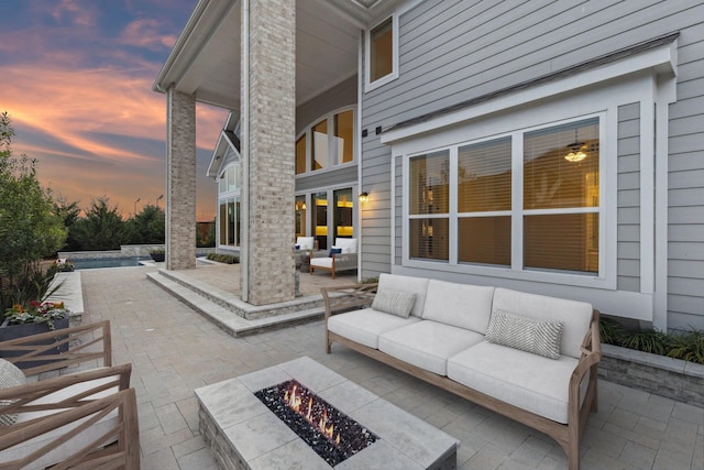 1609 Colonnade Ct, Mckinney, TX 75069 - patio terrace at dusk featuring an outdoor living space with a fire pit and an outdoor pool