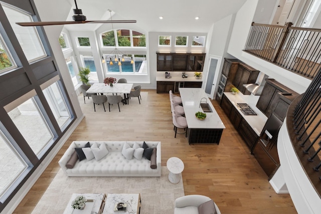 1609 Colonnade Ct, Mckinney, TX 75069 - living area with light wood-style flooring, a ceiling fan, a high ceiling, and recessed lighting