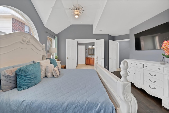 bedroom with lofted ceiling, ensuite bath, wood finished floors, and ceiling fan