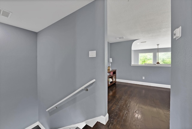staircase with baseboards and wood finished floors