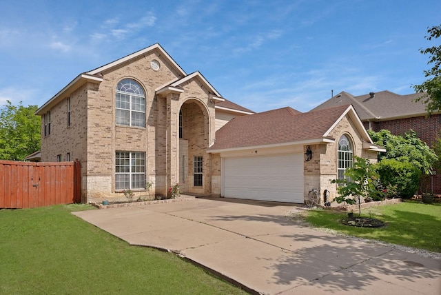 traditional home with brick siding, an attached garage, concrete driveway, and roof with shingles