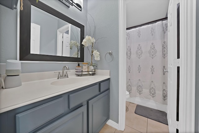 bathroom featuring tile patterned flooring, vanity, toilet, a shower with shower curtain, and a textured wall