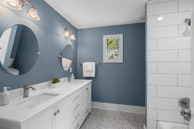 1217 Hawthorne Ave, Fort Worth, TX 76110 - bathroom featuring baseboards, double vanity, and tub / shower combination