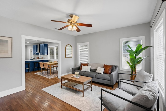 1217 Hawthorne Ave, Fort Worth, TX 76110 - living room with baseboards, ceiling fan, and dark wood-style floors