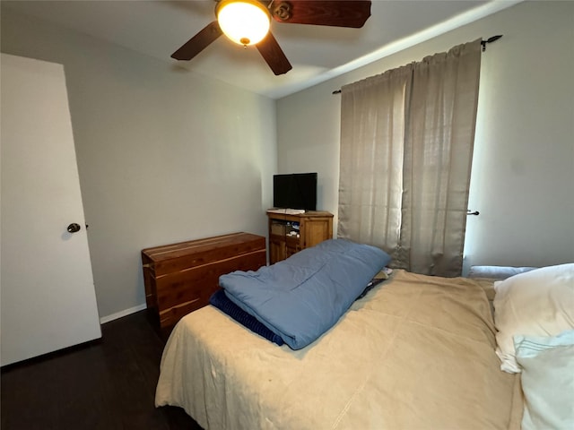 1400 Royal Ln, Cisco, TX 76437 - bedroom with wood finished floors, ceiling fan, and baseboards