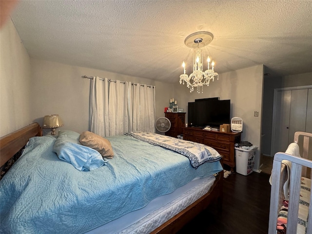 1400 Royal Ln, Cisco, TX 76437 - bedroom featuring a chandelier, dark wood-style flooring, and a textured ceiling