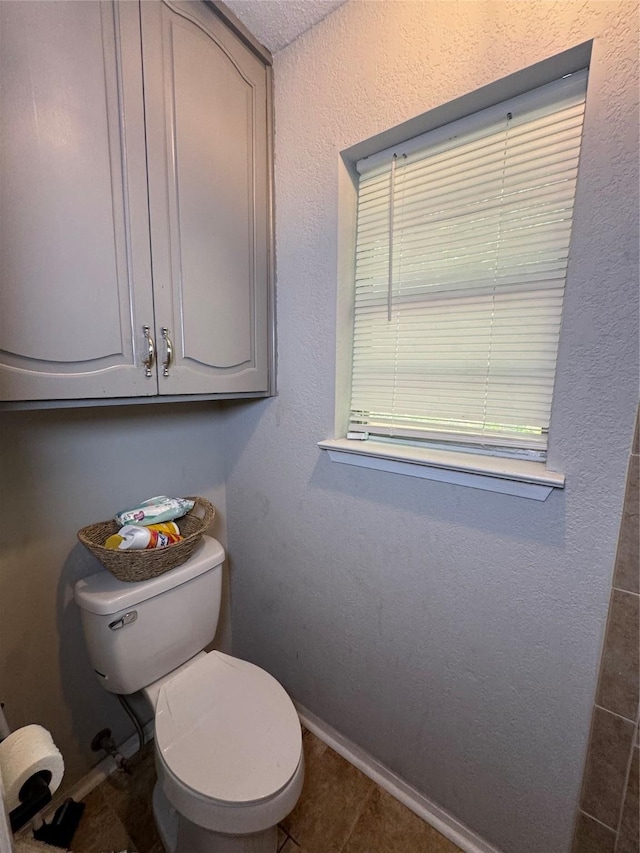 1400 Royal Ln, Cisco, TX 76437 - bathroom with toilet, baseboards, and tile patterned flooring