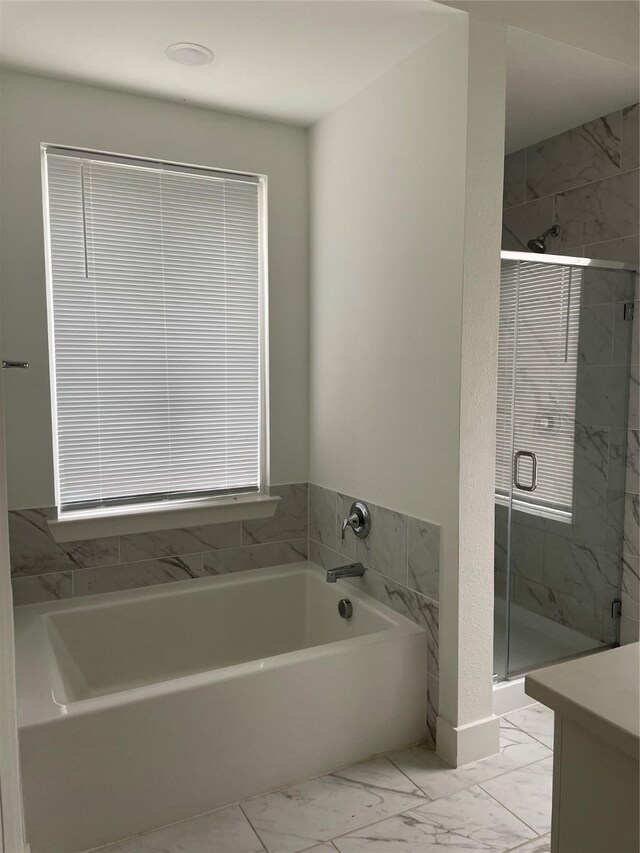 3913 Crystal Cv, Sherman, TX 75090 - bathroom featuring marble look tile flooring, a garden tub, and a stall shower