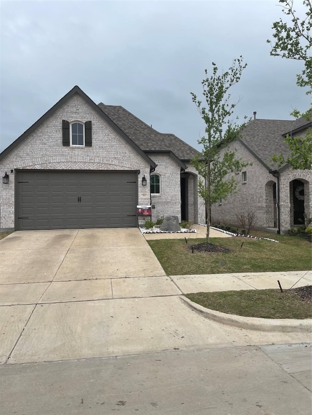 3913 Crystal Cv, Sherman, TX 75090 - french provincial home with driveway, brick siding, and roof with shingles