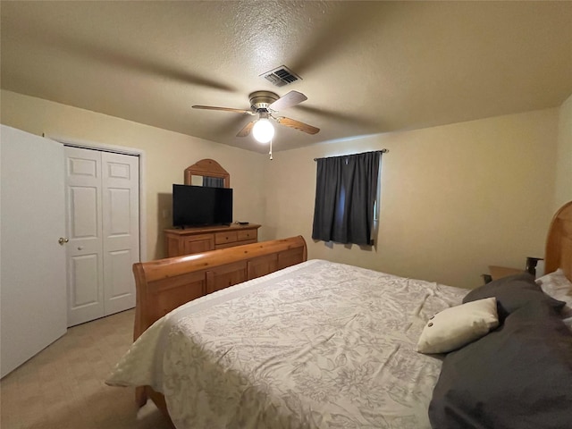 190 Fcr 192, Streetman, TX 75859 - bedroom with light colored carpet, a closet, a ceiling fan, and a textured ceiling