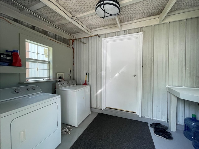 190 Fcr 192, Streetman, TX 75859 - clothes washing area featuring separate washer and dryer and wood walls