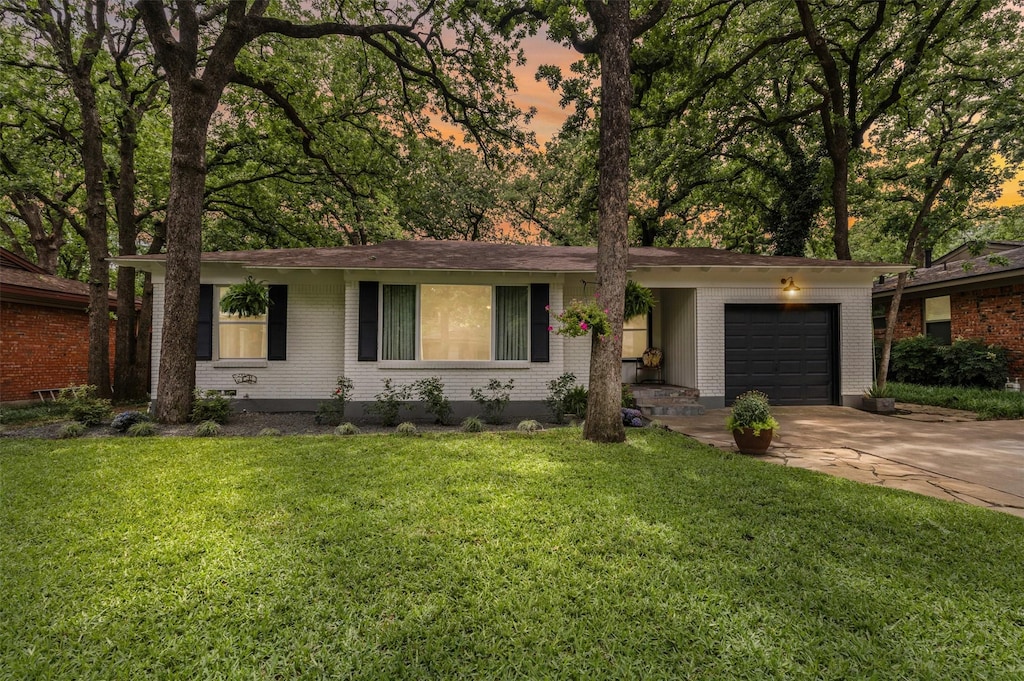 1404 Bluebonnet Trl, Arlington, TX 76013 - single story home with a garage, concrete driveway, brick siding, and a lawn