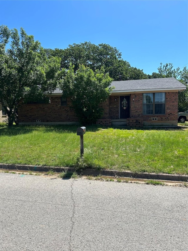1830 S Center St, Denison, TX 75021 - view of front of house featuring brick siding and a front lawn