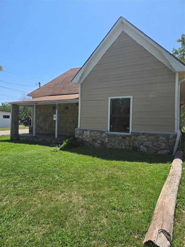 811 Vincent St, Brownwood, TX 76801 - view of side of property with stone siding, a lawn, and roof with shingles