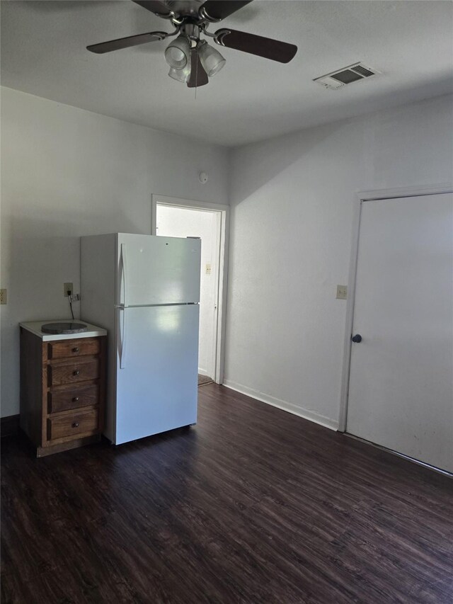 811 Vincent St, Brownwood, TX 76801 - kitchen with freestanding refrigerator, dark wood-type flooring, ceiling fan, and baseboards