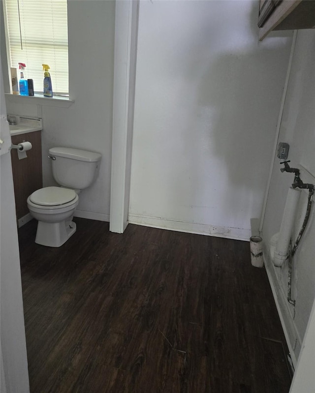 811 Vincent St, Brownwood, TX 76801 - bathroom with toilet, wood finished floors, baseboards, and vanity