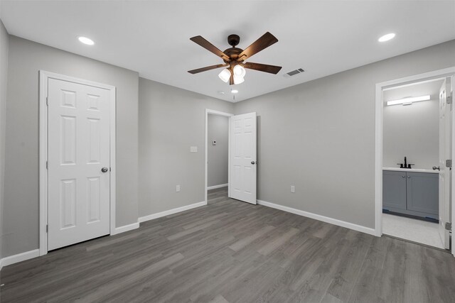 2208 Jane St, Waco, TX 76711 - unfurnished bedroom with wood finished floors, recessed lighting, baseboards, ensuite bathroom, and a ceiling fan