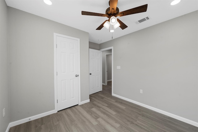 2208 Jane St, Waco, TX 76711 - unfurnished bedroom with wood finished floors, baseboards, recessed lighting, and a ceiling fan
