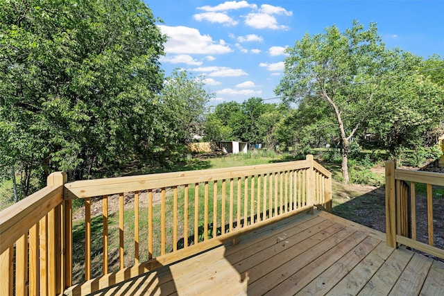 2208 Jane St, Waco, TX 76711 - wooden deck with an outbuilding, a shed, a yard, and view of wooded area