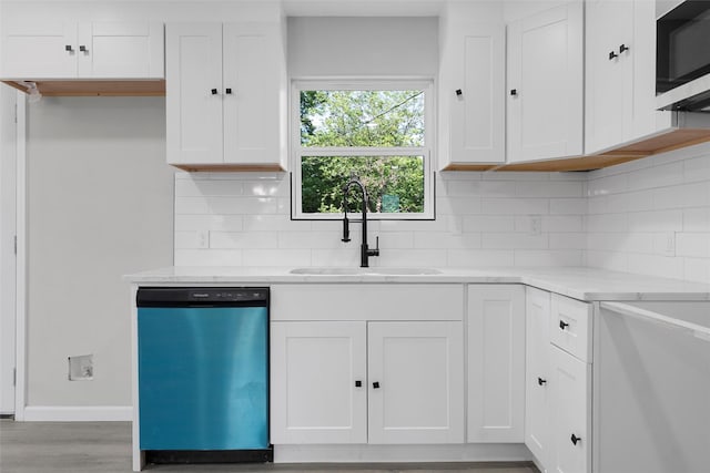 2208 Jane St, Waco, TX 76711 - kitchen with dishwasher, stainless steel microwave, a sink, tasteful backsplash, and white cabinets