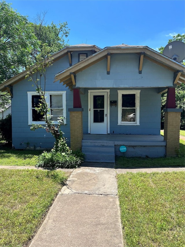 bungalow-style house with a porch and a front lawn