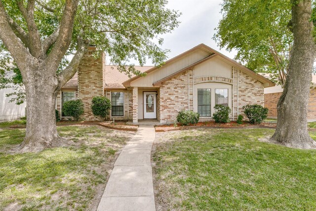 9306 Grant Dr, Rowlett, TX 75088 - view of front of property with brick siding, a front lawn, and a chimney