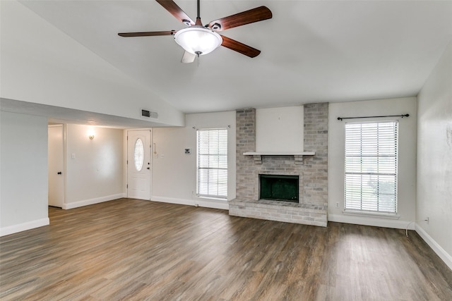 9306 Grant Dr, Rowlett, TX 75088 - unfurnished living room with ceiling fan, healthy amount of natural light, wood finished floors, and vaulted ceiling