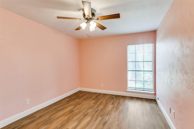 9306 Grant Dr, Rowlett, TX 75088 - unfurnished room featuring wood finished floors, a ceiling fan, and baseboards
