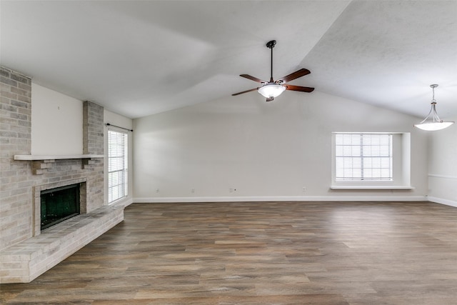 9306 Grant Dr, Rowlett, TX 75088 - unfurnished living room featuring lofted ceiling, a ceiling fan, wood finished floors, baseboards, and a fireplace
