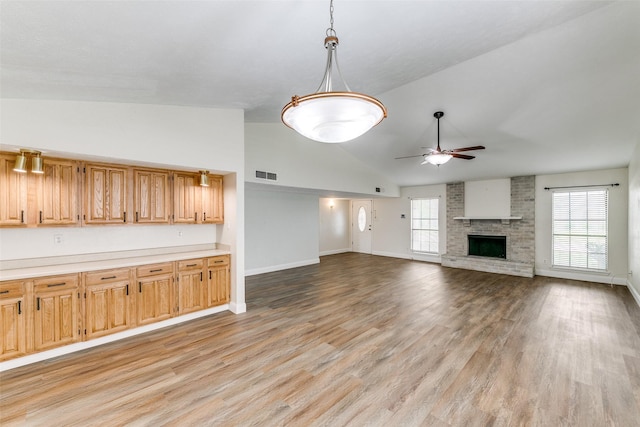 9306 Grant Dr, Rowlett, TX 75088 - unfurnished living room with a ceiling fan, light wood-style floors, baseboards, a fireplace, and high vaulted ceiling