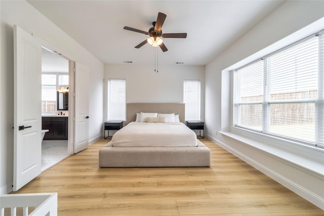4506 Sky Harbor Dr, Rockwall, TX 75087 - bedroom featuring light wood-style flooring, ensuite bathroom, baseboards, and a ceiling fan
