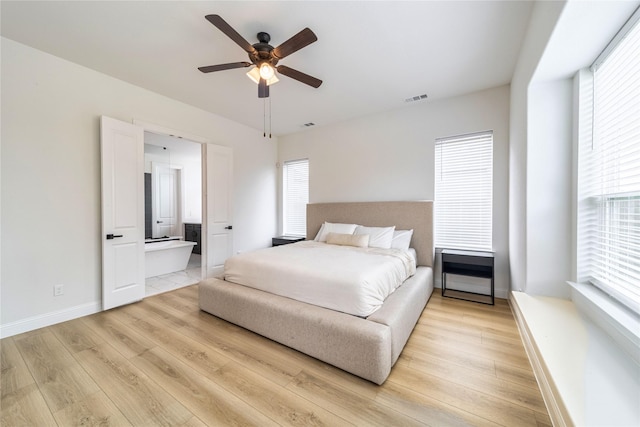 4506 Sky Harbor Dr, Rockwall, TX 75087 - bedroom featuring light wood-style flooring, baseboards, a ceiling fan, and ensuite bath