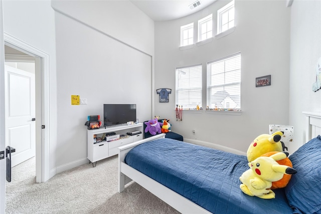 4506 Sky Harbor Dr, Rockwall, TX 75087 - bedroom featuring light carpet, a towering ceiling, and baseboards
