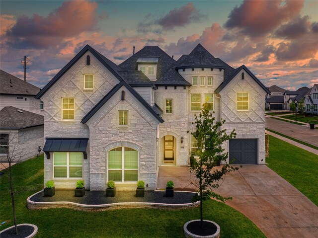 4506 Sky Harbor Dr, Rockwall, TX 75087 - french country style house with a garage, a front yard, concrete driveway, stone siding, and a standing seam roof