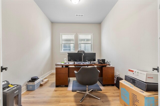 office with light wood-style flooring