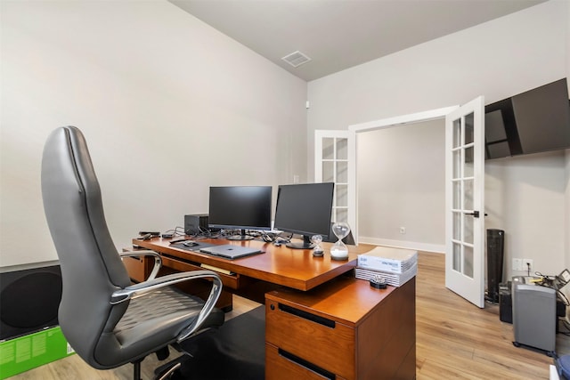 office space with french doors and light wood-style flooring