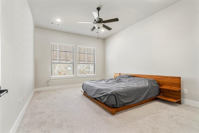 carpeted bedroom featuring baseboards and ceiling fan