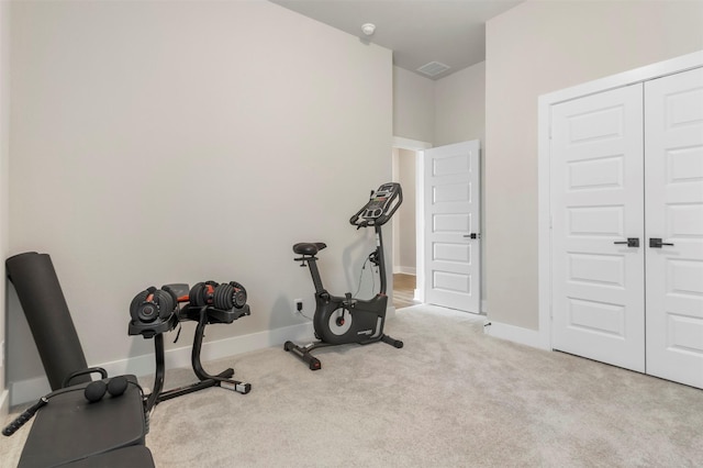 workout area with carpet flooring and baseboards